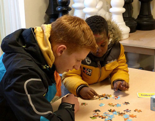 Jugendliche arbeiten gemeinsam an einem Puzzle.